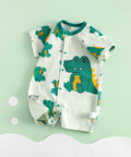 Baby romper with crocodile pattern on a light green background