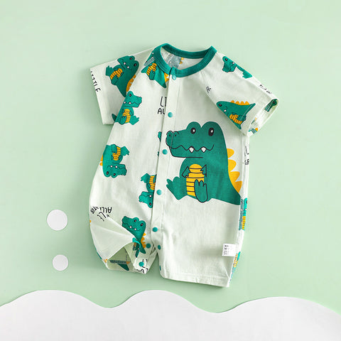 Baby romper with crocodile pattern on a light green background
