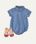 Denim baby romper with red shoes on a light gray background