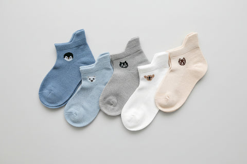 Set of five pairs of socks in blue, gray, white, and beige with animal .