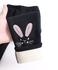 Black sleeve with a bunny design held by a hand on a white background