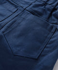 Close-up of blue pants with a pocket on a gray background
