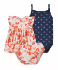 Two children's swimsuits, one floral and one navy with white pattern, on a white background.