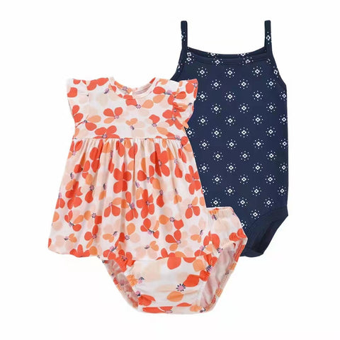 Two children's swimsuits, one floral and one navy with white pattern, on a white background.