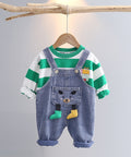 Children's outfit with striped shirt and denim overalls on a hanger against a gray background