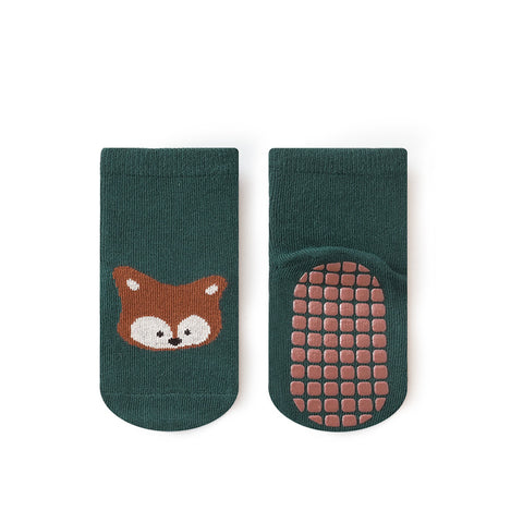 Green socks with a fox design and textured sole on a white background