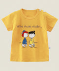 Yellow t-shirt with cartoon characters and text on a hanger against a white background