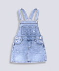 Light blue denim pinafore dress with suspenders on a white background