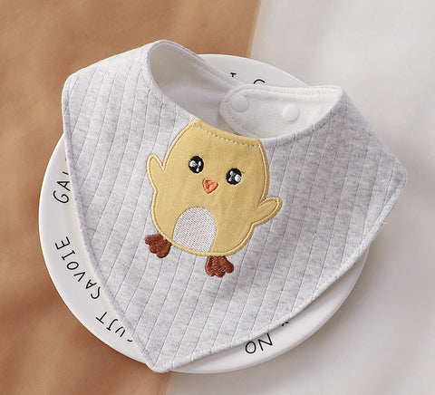 Gray baby bib with a chick design on a white surface