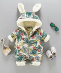 Floral-patterned baby snowsuit with bunny ears on a gray background