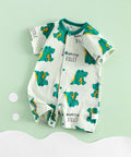 Baby romper with dinosaur pattern on a light green background