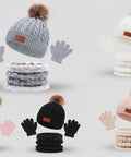 Collection of winter hats, scarves, and gloves in various colors with pom-poms on a white background.