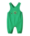 Green children's overalls with dinosaur design on a white background