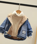 Children's denim jacket with fleece lining on a hanger against a neutral background
