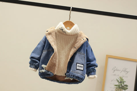 Children's denim jacket with fleece lining on a hanger against a neutral background