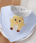 Baby bib with chick design on a white background
