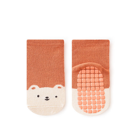 Pair of baby socks with bear face design on a white background