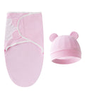 Pink baby swaddle and hat set on a white background