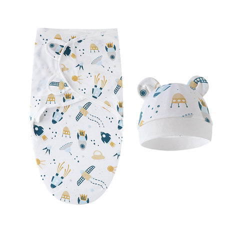 Baby swaddle blanket with geometric pattern and matching hat on a white background